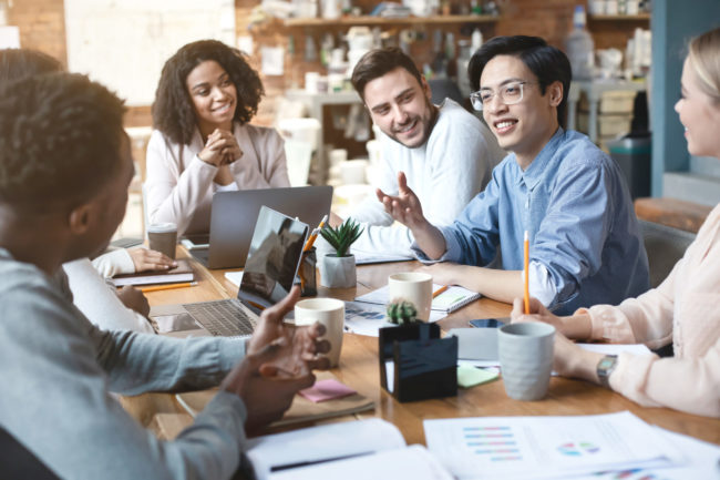 Close up of young people having business meeting in office